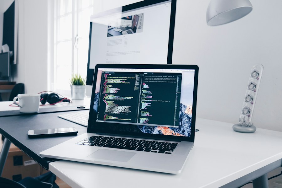 Laptop showing code in a bright workspace