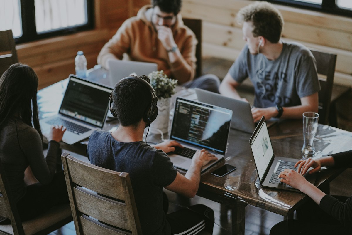 Product team collaborating around a laptop